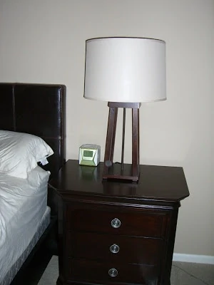A wooden side table and lamp.