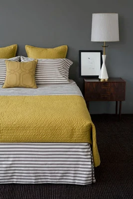 A bright yellow and striped bedding.