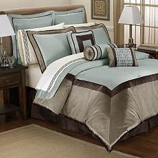 Soft blue, brown bedding on a bed.