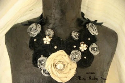 A black and off white floral necklace.