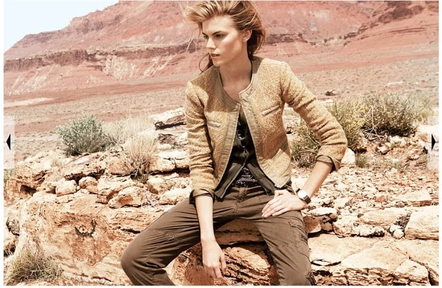 The model sitting on the rock wearing military type pants.