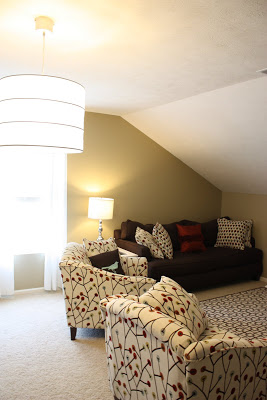 A small sitting room with a couch, love sofa, and a armchair.