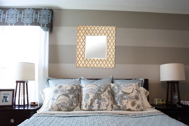 A pearl lustre mirror above the bed.
