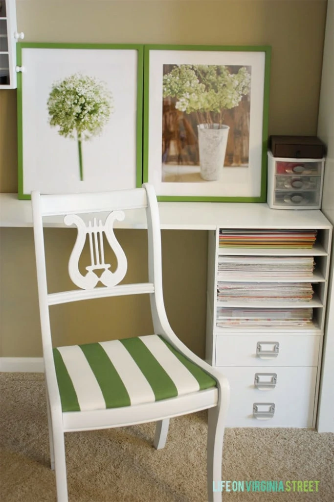 The chair painted white with a green and white striped pad.