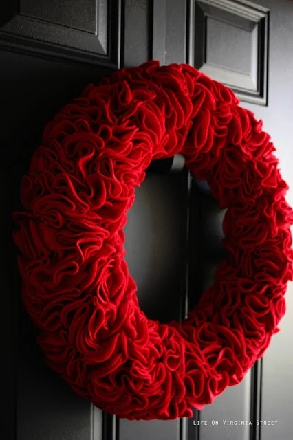 Side view of the red ruffles hanging on the wooden door.