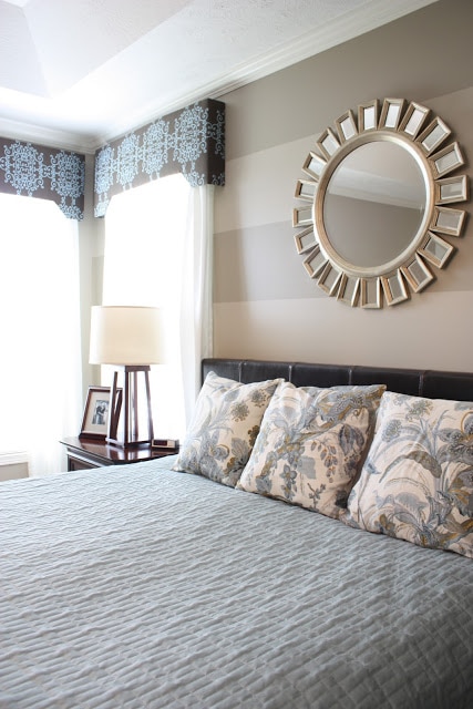 There is a small lamp on the tables beside the bed.