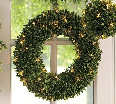 Boxwood wreath hanging in the window.