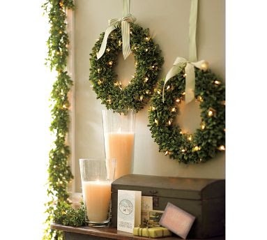 Wreaths hanging above the side table with candles.