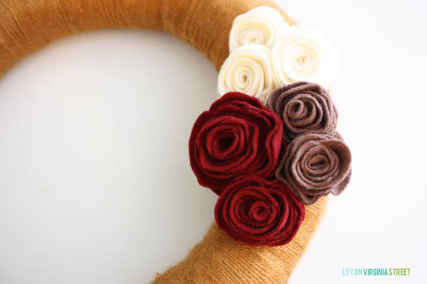 Up close picture of the red, white, and light purple flowers on wreath.
