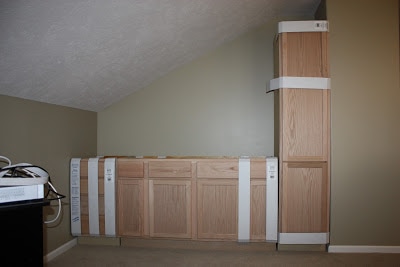 Cabinets being installed into the room.