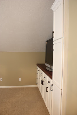 DIY entertainment center with kitchen cabinets side view.