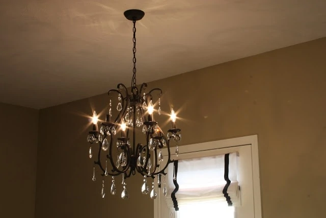 Pottery Barn Celeste Chandelier hanging up in the dining room.