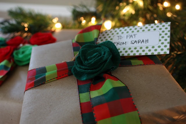 Kraft paper with green rosette flower on top of the present.