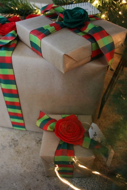 The presents wrapped in paper with red and green bows and striped ribbon.
