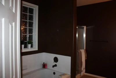 The bathroom before painting with very dark walls.