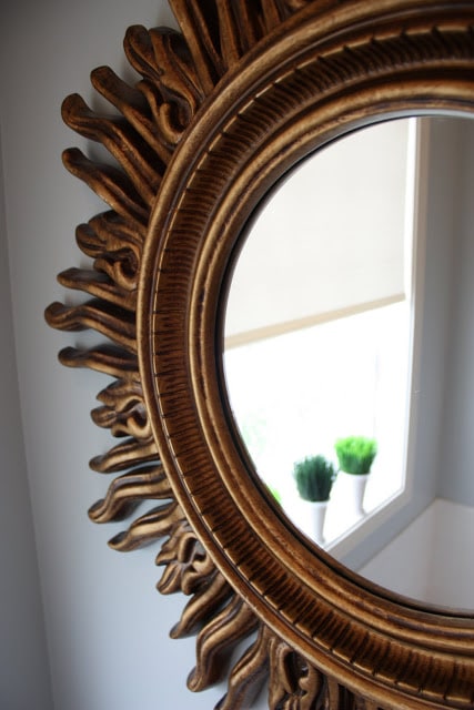 A golden mirror in the bathroom.