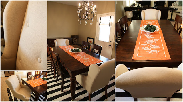 Wooden dining room table with chandelier above it.
