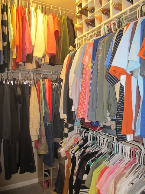 The master bedroom closet organized with his and hers clothes.