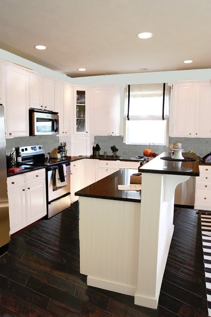 A white kitchen with the Carrera Marble subway tiles.