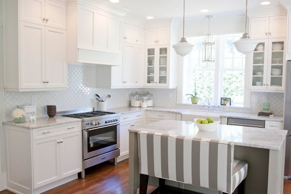 White tile behind the stove in the kitchen.