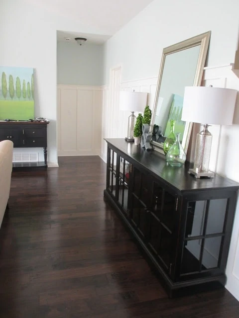 Living room with dark hardwood floors and Healing Aloe paint color walls