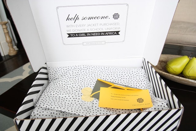 The lid of the box opened with polka dotted tissue inside.