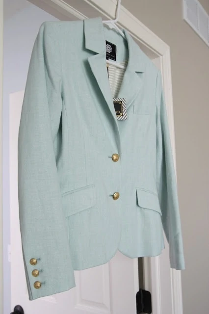 A light blue/green suit jacket with gold buttons.