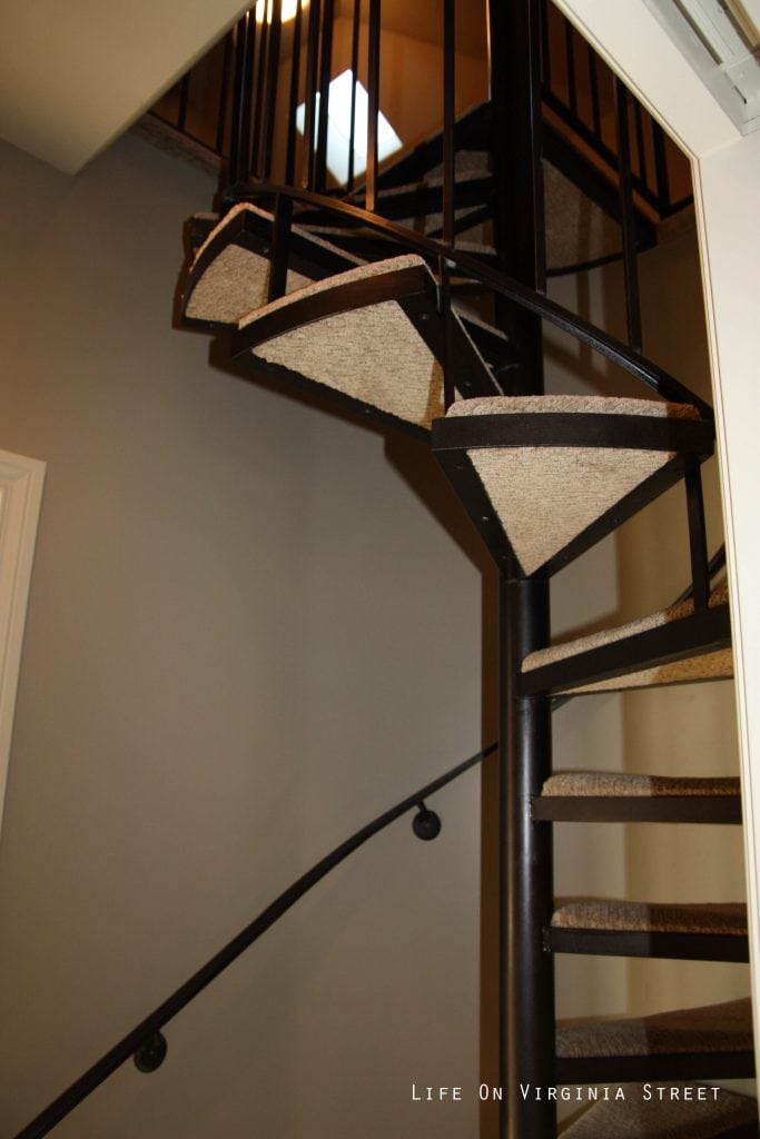 A spiral staircase leading to a top floor.
