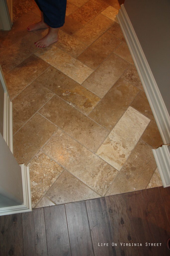 Herringbone patterned travertine floors.