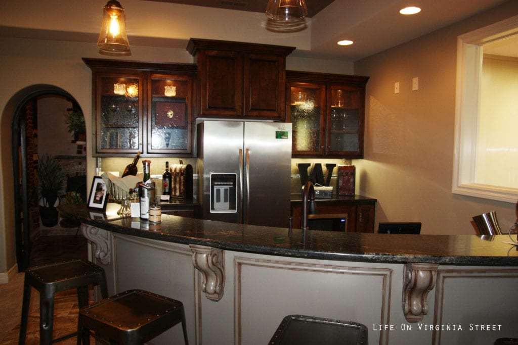 A full stainless steel fridge in the recreation room.