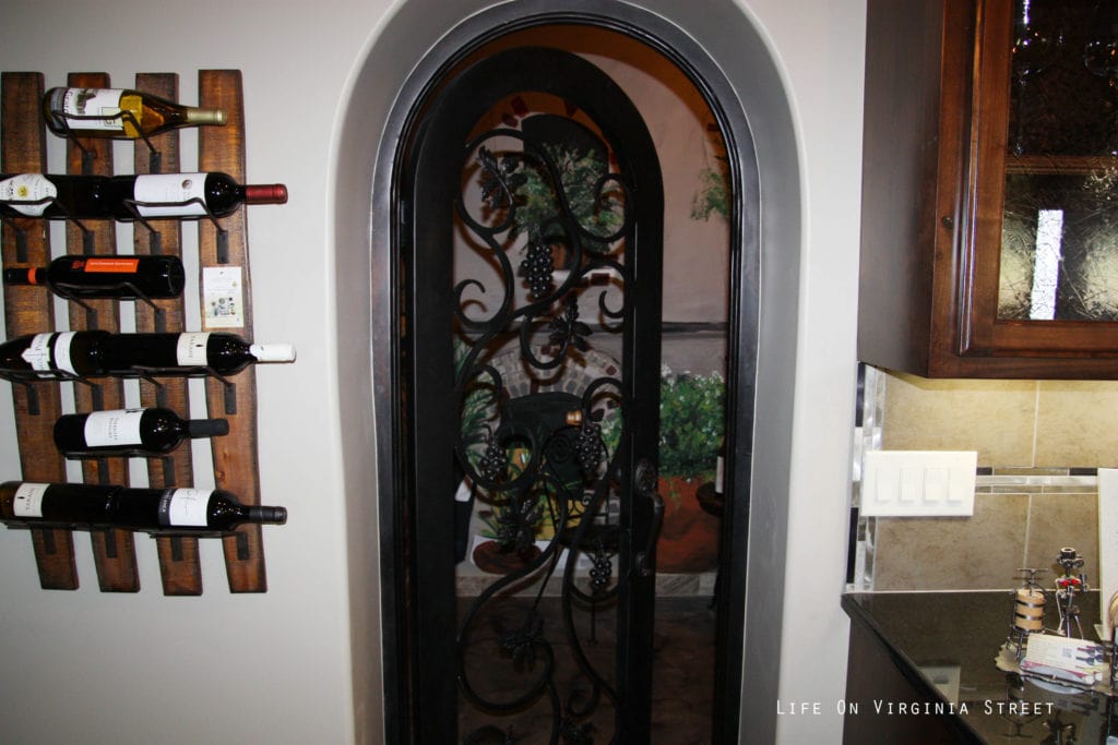 Wine bottles on a wooden rack in the downstairs room.
