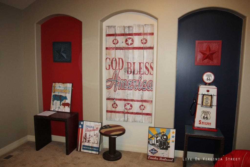 A God Bless America wooden sign in a child's playroom.