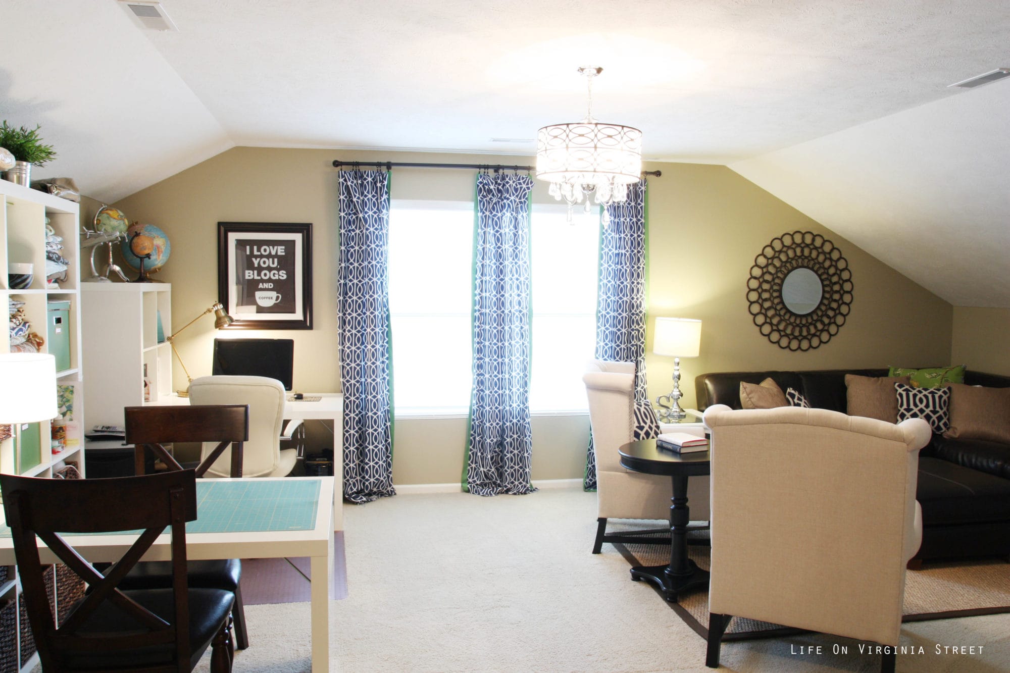 The upstairs sitting room with sloped ceilings and a small craft table.