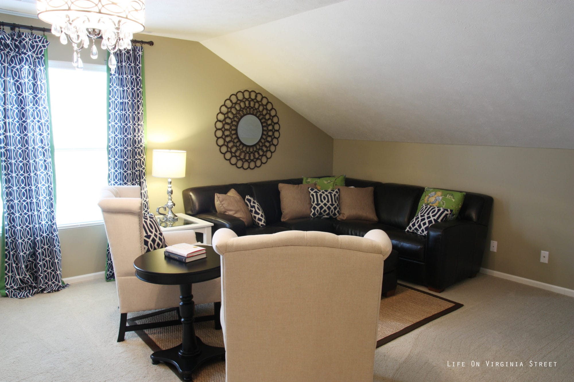 A sectional sofa is in the sitting room beside the window.