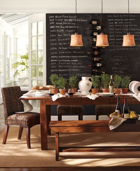 Bench seating in coffee shop with chalkboard behind it.