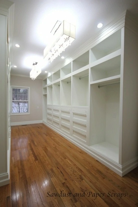 White closet with hardwood floors.