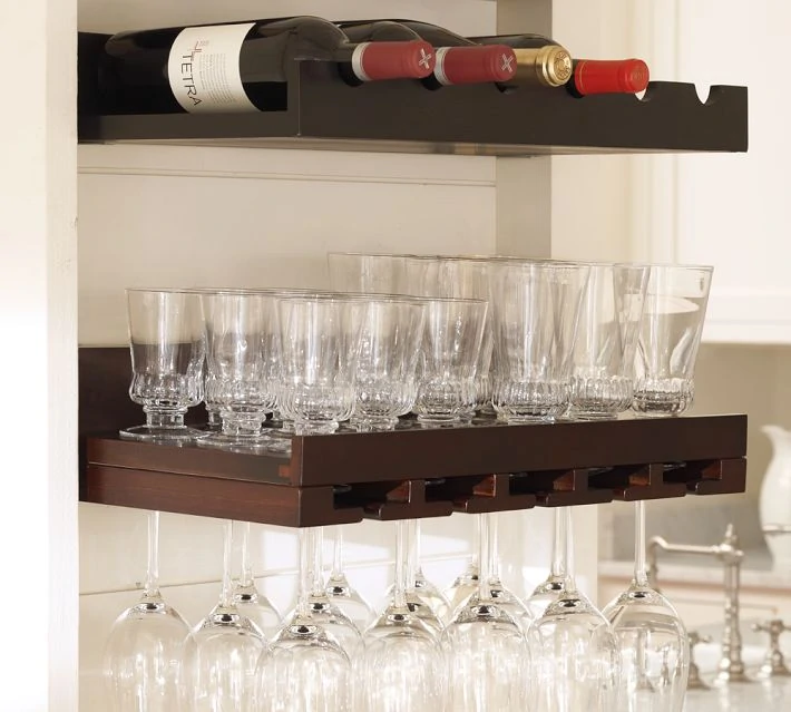 Woodend shelves holding clear glasses, wine glasses and wine bottles.