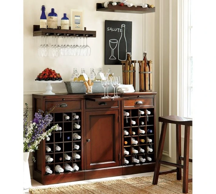 Pottery Bar wooden entertaining shelf with wine bottles in it.