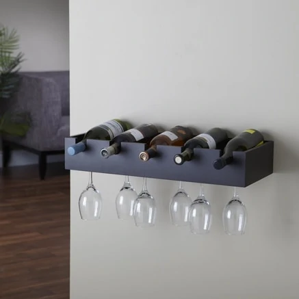 Black wine rack on the wall with a couch in the background.