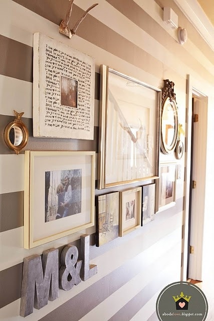 A brown and white striped wall with pictures of a family on it.