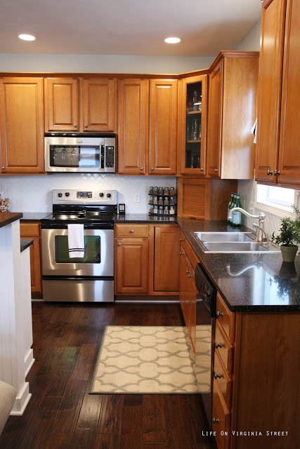 White Moroccan Tile backsplash in kitchen with stainless steel stove and microwave.