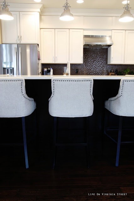 Linen Bar Stools next to Black Kitchen Island