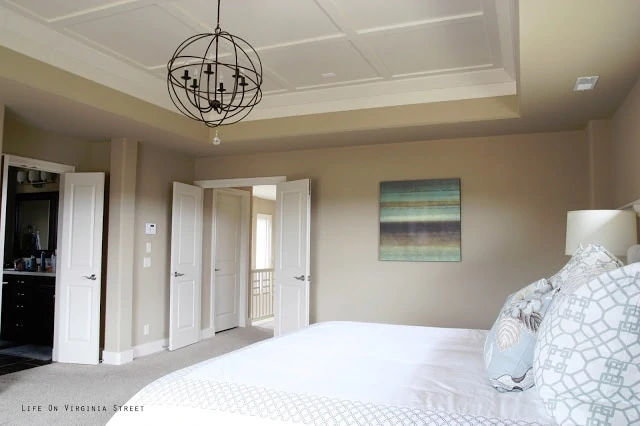 Orb Chandelier in a Master Bedroom with a bed and a picture on the wall.
