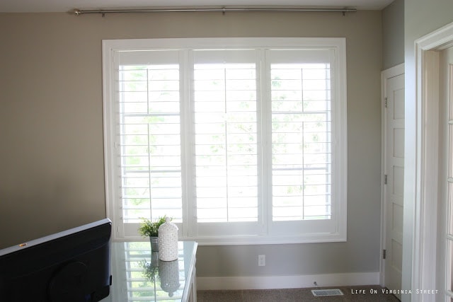 Office window with white plantation shutters.