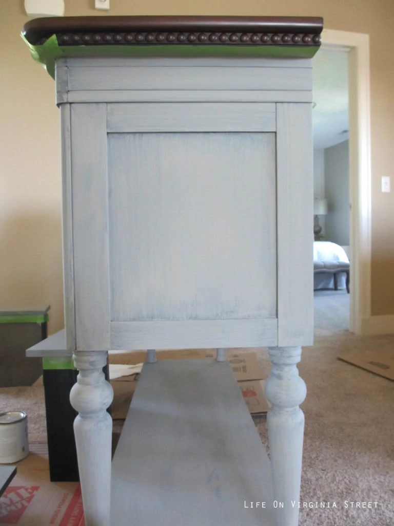 DIY chalk paint buffet project. One coat of gray chalk paint on a black buffet table.