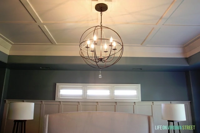 Showing off the Behr Atmospheric paint color on our master bedroom walls and the round light fixture.