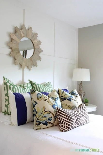 White Board and Batten Grid Wall with Designer Pillows on Bed