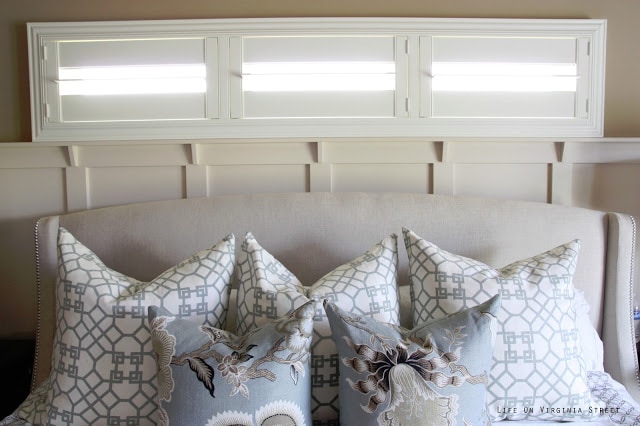 Master bedroom with Schumacher Hothouse Flowers and Windsor Smith Pelagos pillows. This headboard needs a little love, especially when compared to these gorgeous white shutters.