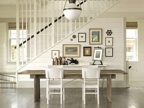 Cute gallery wall on shiplap leading up a staircase. 
