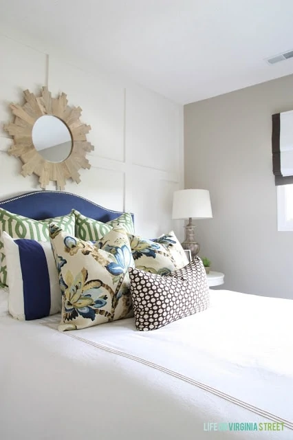 Gorgeous neutral guest bedroom with a blue headboard. Love the pillow fabric combo!